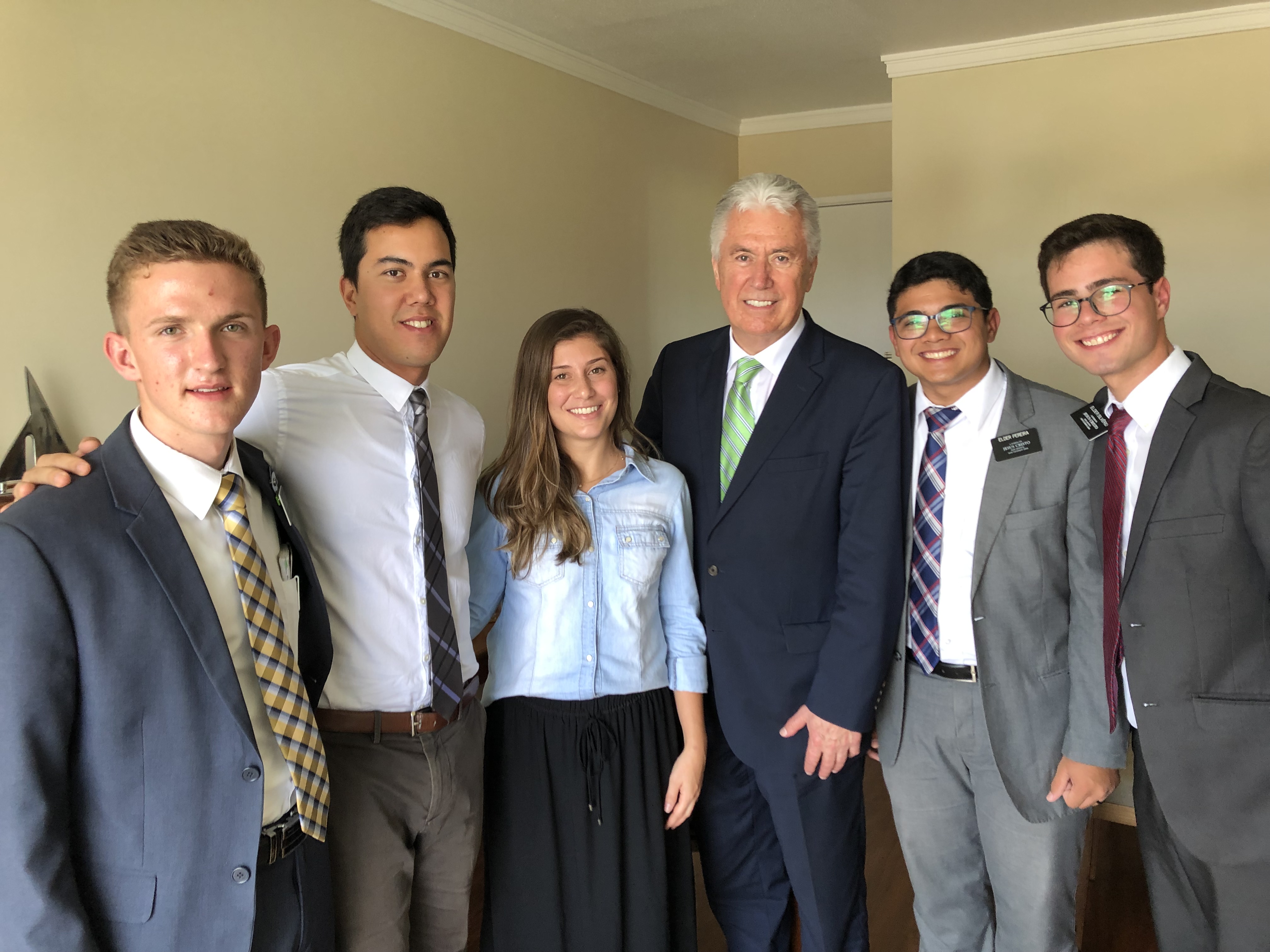Elder Dieter F. Uchtdorf of the Quorum of the Twelve Apostles, pose for a photo with Zenon and Natalia Spaveevskas in their apartment after lesson with Elders Brennan Lance Stimpson, Gabriel Luiz Rodriguez Silvério and Leonário Lima Pereira of the Brazil São Paulo West Mission in February 2019.