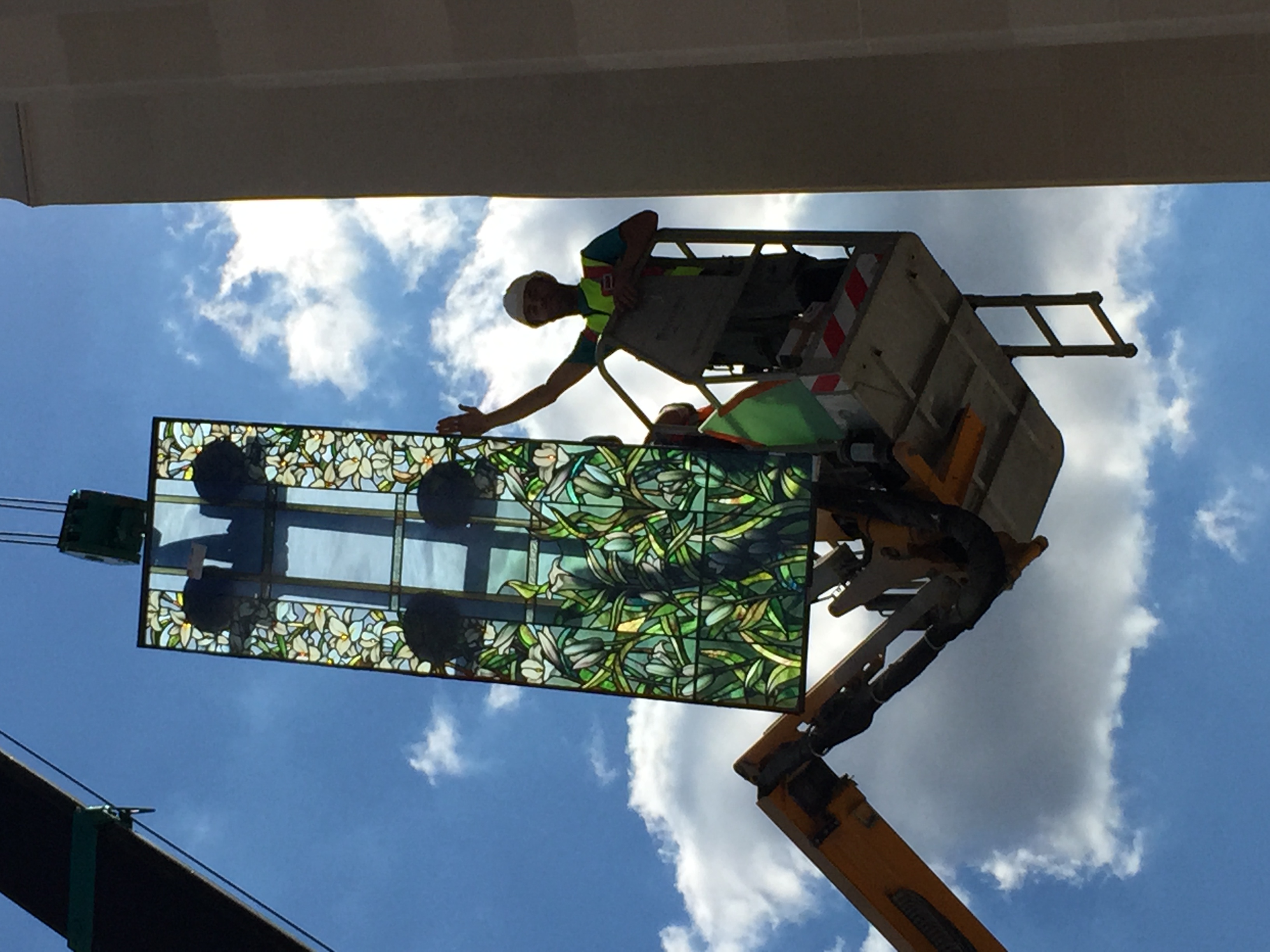 Workmen raise the madonna lily windows to install on the Paris France Temple.
