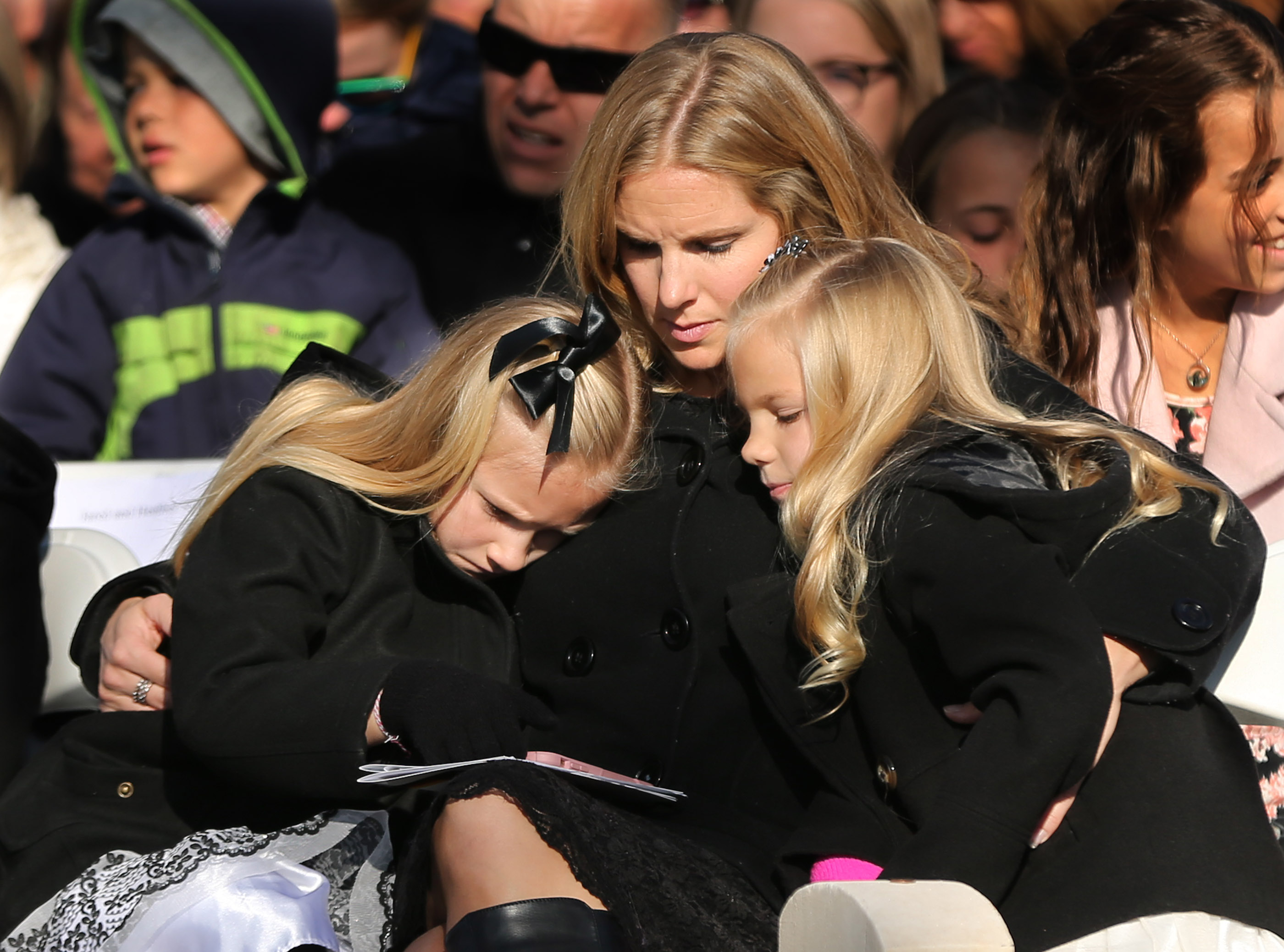 Emmy Gourley holds her children Madisen and Abigail during the German Day of Remembrance (Volkstrauertag) at Fort Douglas Military Cemetery in Salt Lake City on Sunday, Nov. 18, 2018.