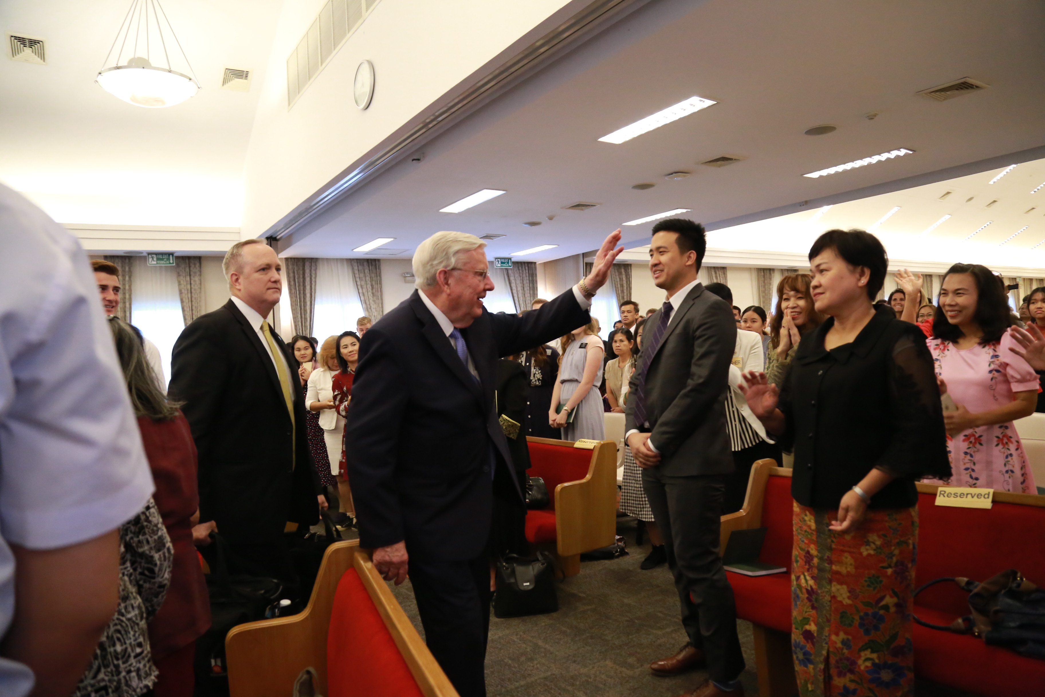 President M. Russell Ballard waves to members after speaking at a stake conference in the Thailand Bangkok North Stake in May 2019.