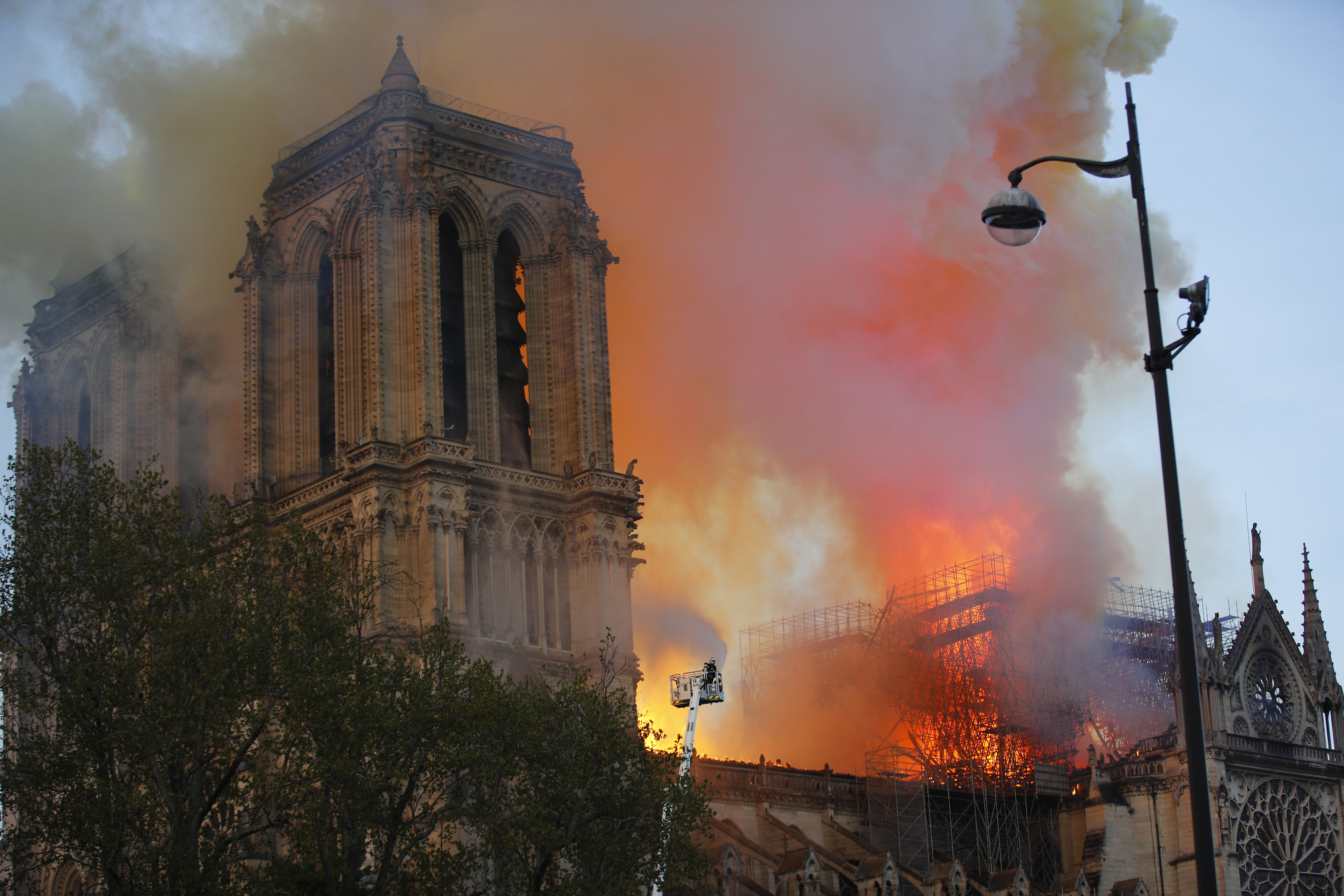 Firefighters use hoses as Notre Dame cathedral burns in Paris, Monday, April 15, 2019. A catastrophic fire engulfed the upper reaches of Paris' soaring Notre Dame Cathedral as it was undergoing renovations Monday, threatening one of the greatest architectural treasures of the Western world as tourists and Parisians looked on aghast from the streets below. (AP Photo/Francois Mori)