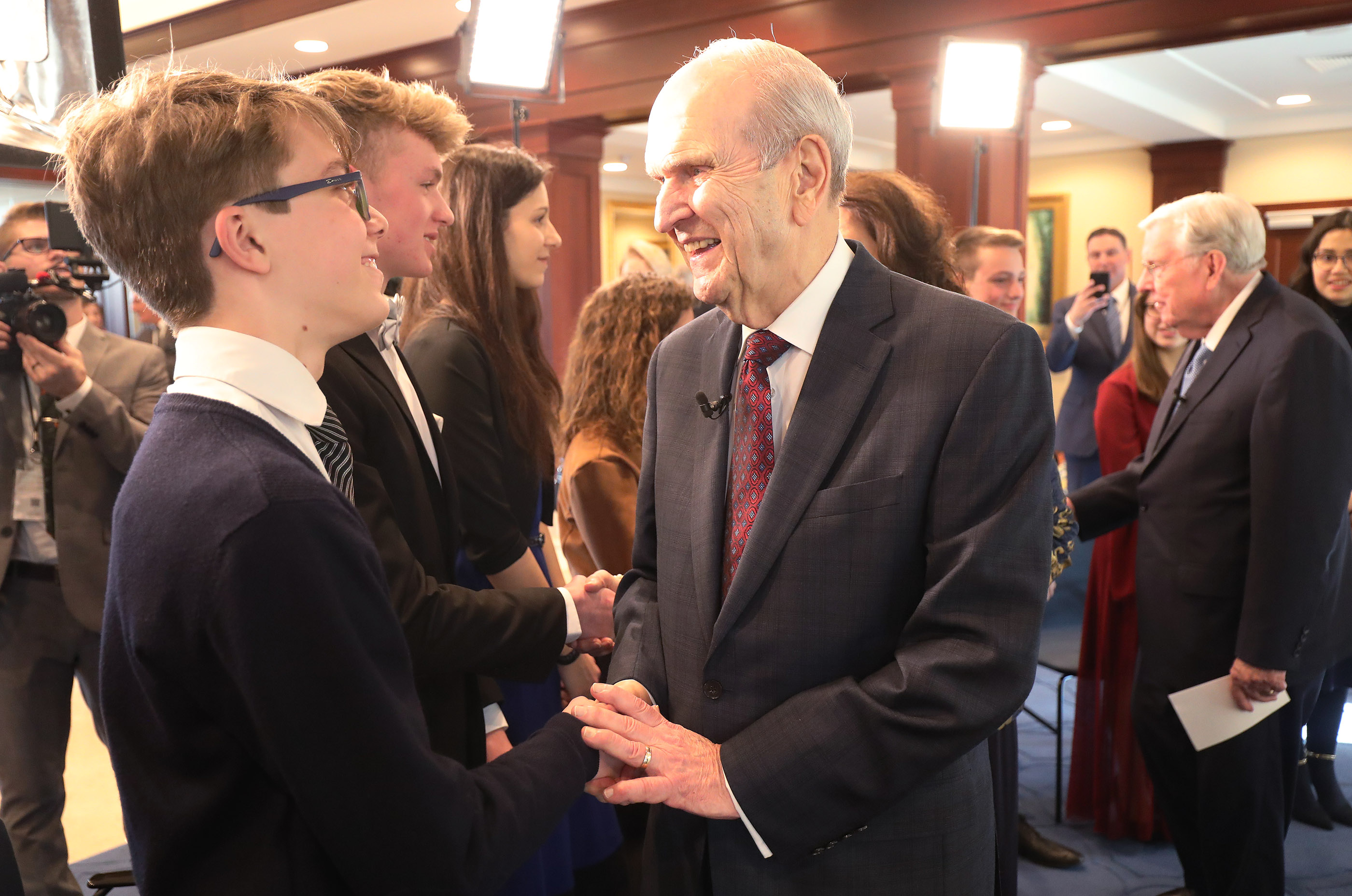President Russell M. Nelson of The Church of Jesus Christ of Latter-day Saints and President M. Russell Ballard, acting president of the Quorum of the Twelve Apostles, meet with youth in the Rome Temple Visitors' Center prior to a youth devotional in Rome, Italy, on Saturday, March 9, 2019.