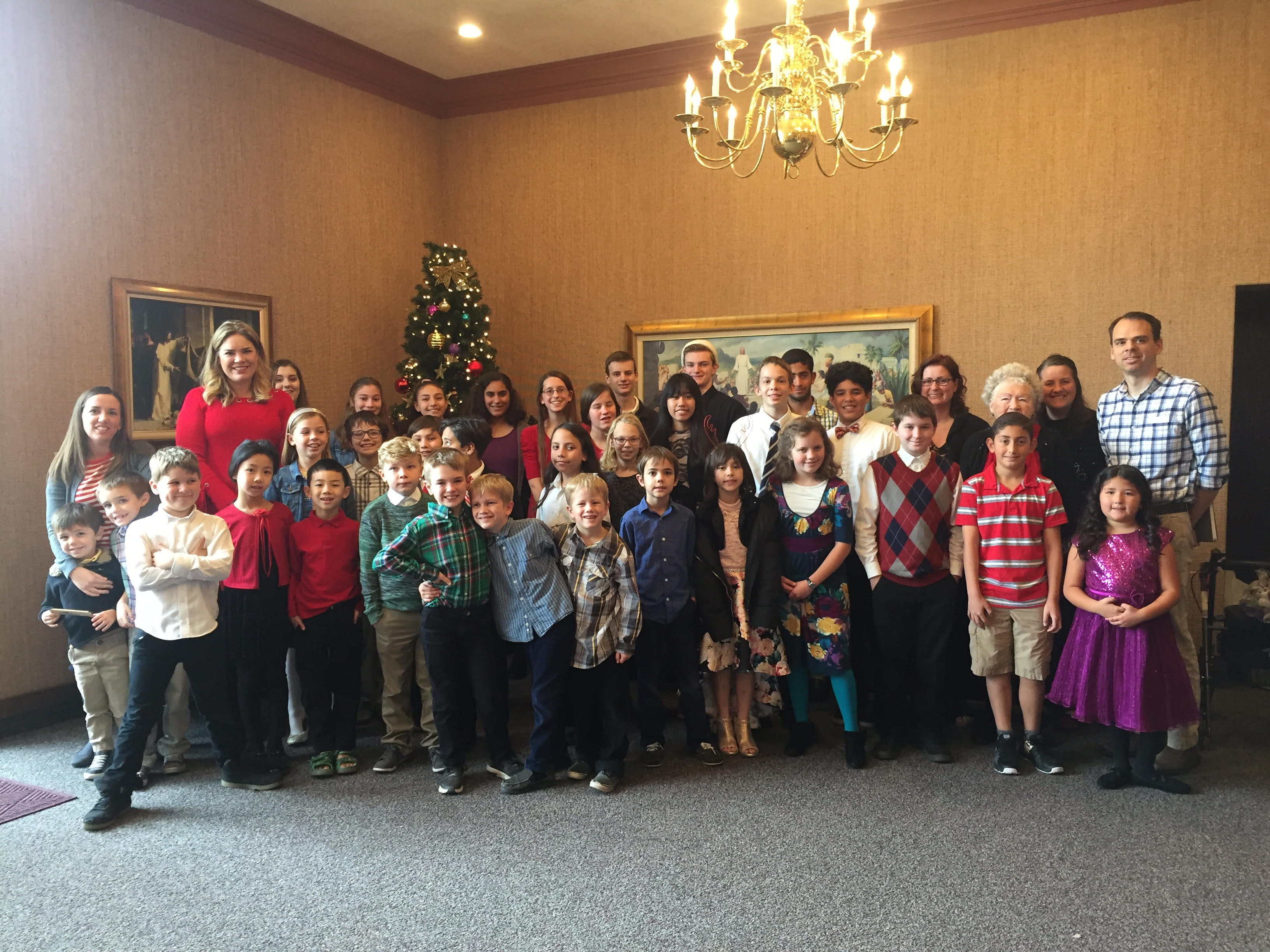 Students and parents pose with Gay Goaslind at one of their semiannual recitals.