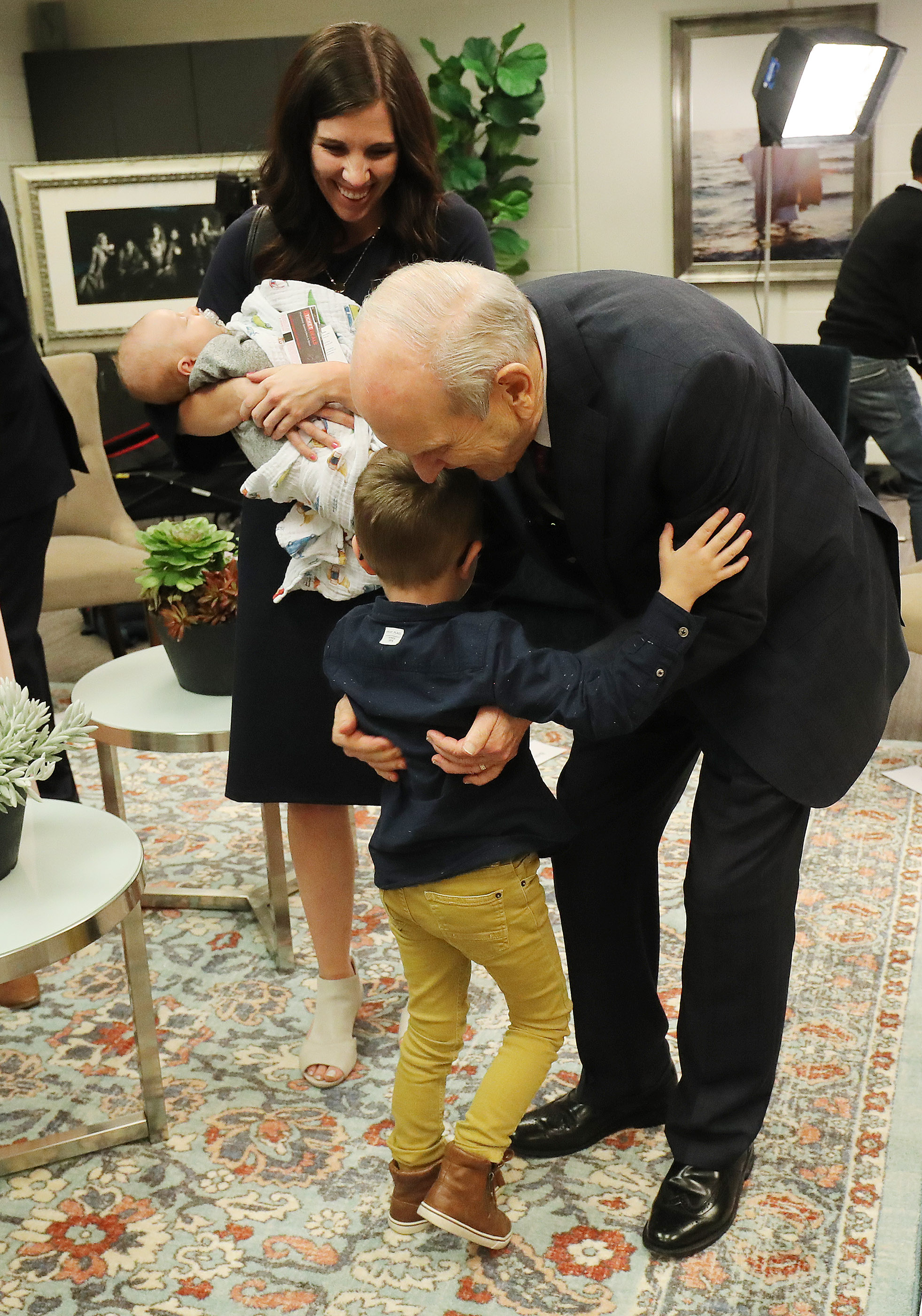 President Russell M. Nelson of The Church of Jesus Christ of Latter-day Saints hugs his great-grandson Madden Walker as his mother, Allie Walker, watches prior to a devotional at the State Farm Stadium in Phoenix on Sunday, Feb. 10, 2019.