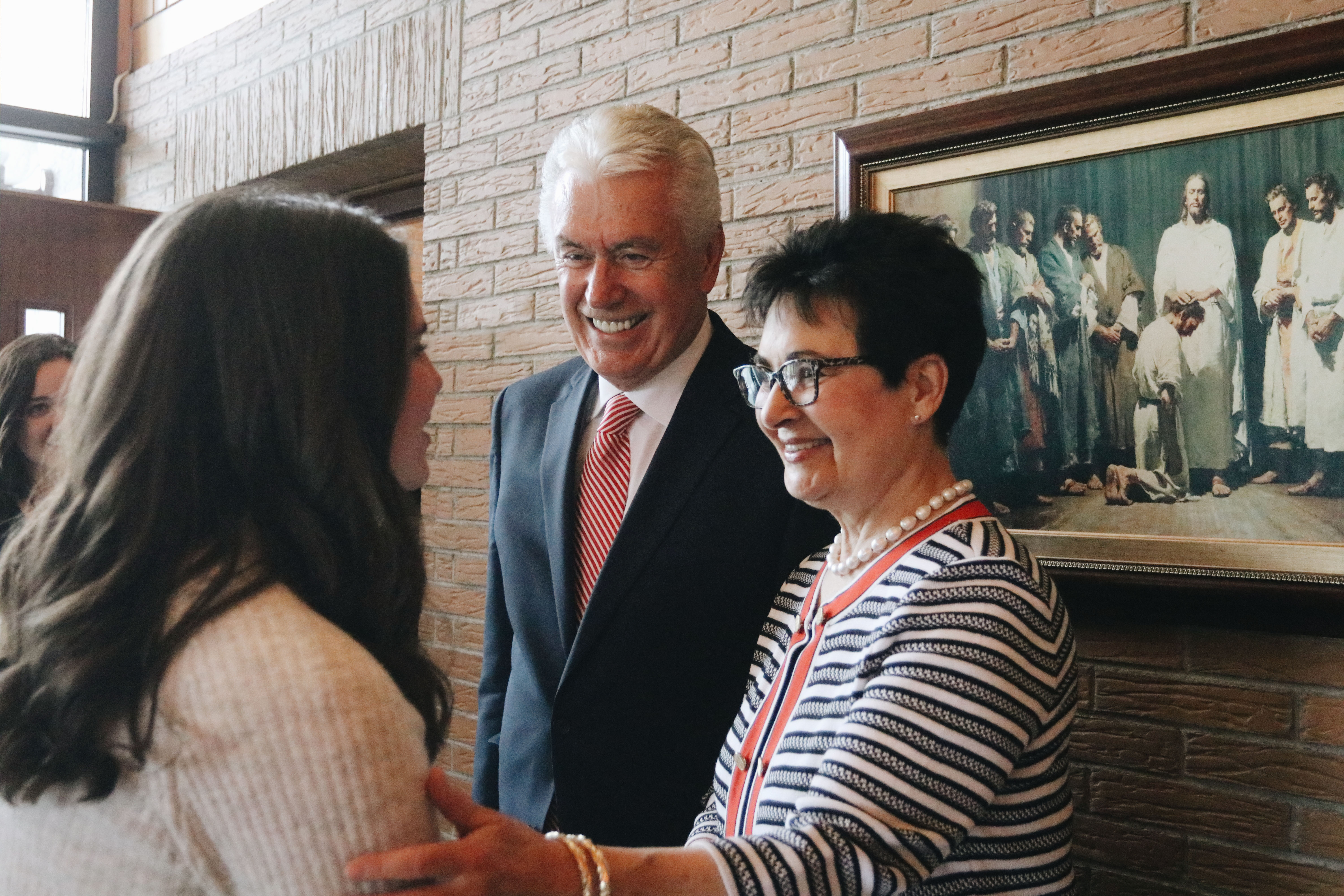Elder Dieter F. Uchtdorf and Sister Harriet Uchtdorf greet missionaries of the Alpine German-Speaking Mission following a mission meeting in Salzburg, Austria, on April 14, 2019.