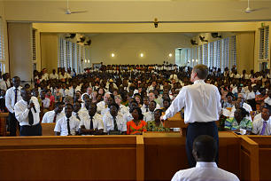 Elder David A. Bednar speaks to members during a meeting held in Accra, Ghana.