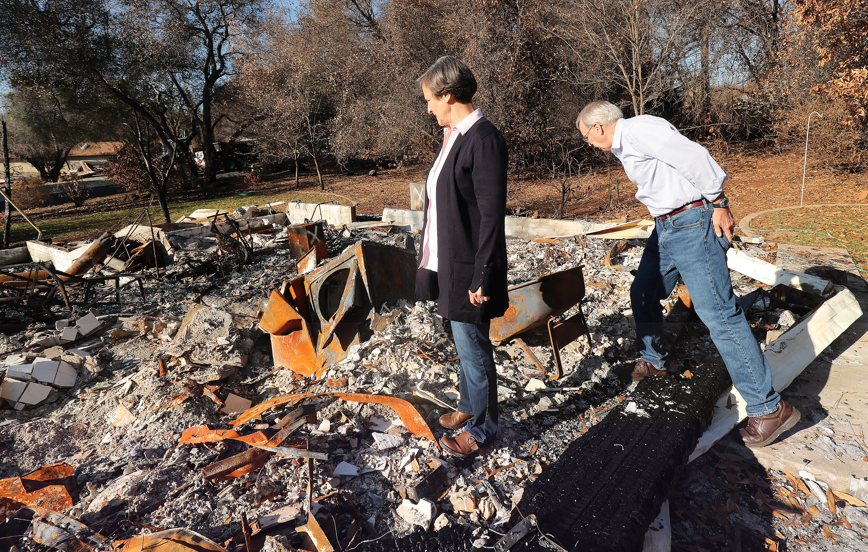 Rick and Kathie Turner look over their destroyed home in Paradise, California, on Saturday, Jan. 12, 2019, two months after the Camp Fire destroyed more than 18,000 homes and businesses.