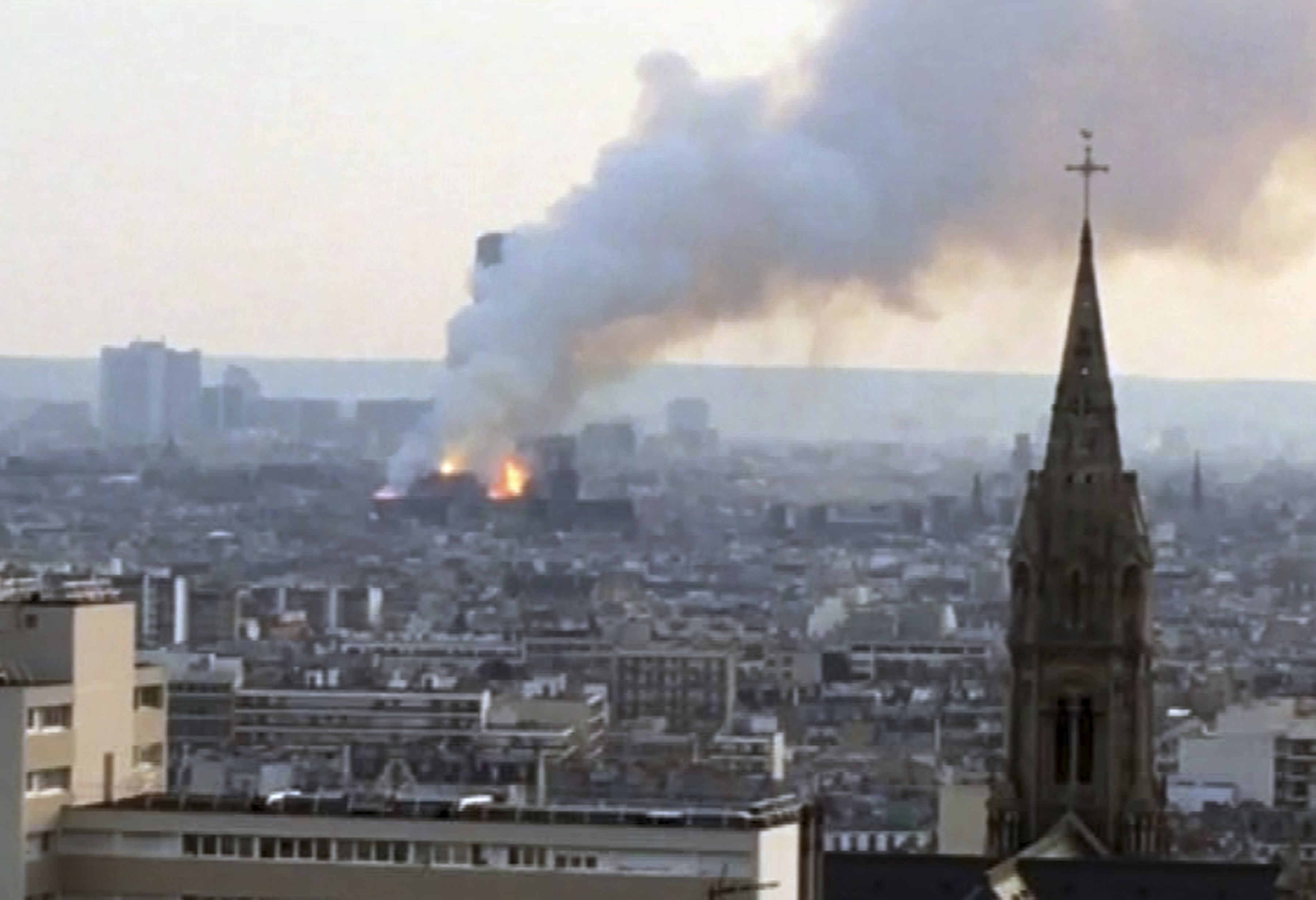 Plumes of smoke rises from Notre Dame cathedral burning in Paris, Monday, April 15, 2019. Massive plumes of smoke fills the air above Notre Dame Cathedral and ash is reported to be falling on tourists and others around the island that marks the center of Paris. (AP Photo)