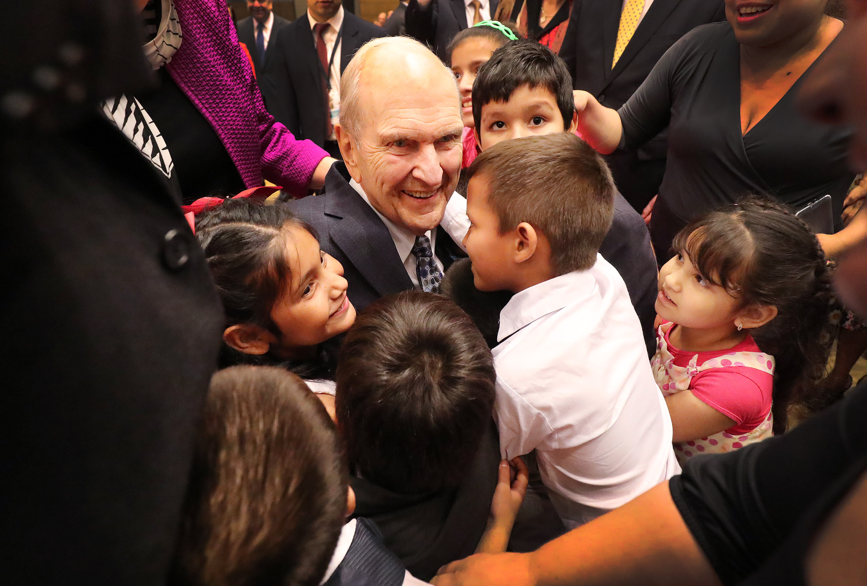 President Russell M. Nelson receives a hug from children after a devotional in Asuncion, Paraguay, on Monday, Oct. 22, 2018.