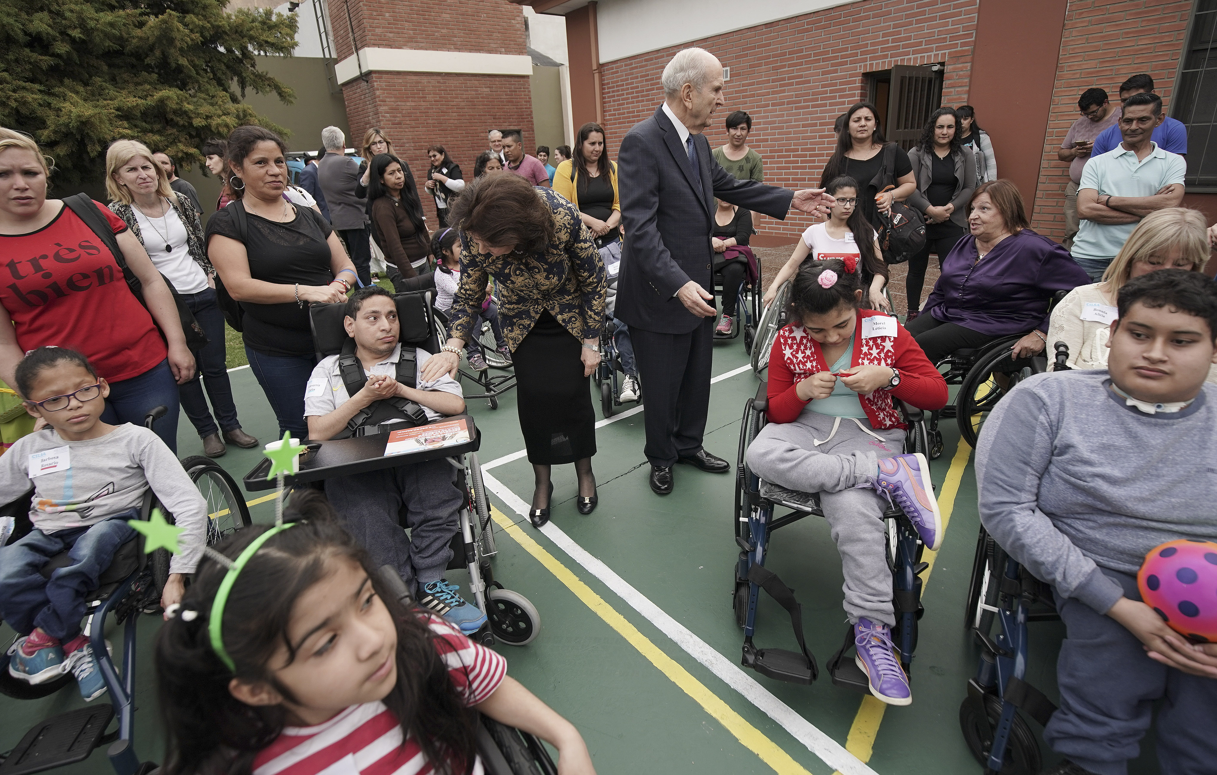 President Russell M. Nelson of The Church of Jesus Christ of Latter-day Saints and his wife, Sister Wendy Nelson, stand with wheelchair recipients after Latter-day Saint Charities donated the wheelchairs in Buenos Aires, Argentina, on Wednesday, Aug. 28, 2019.