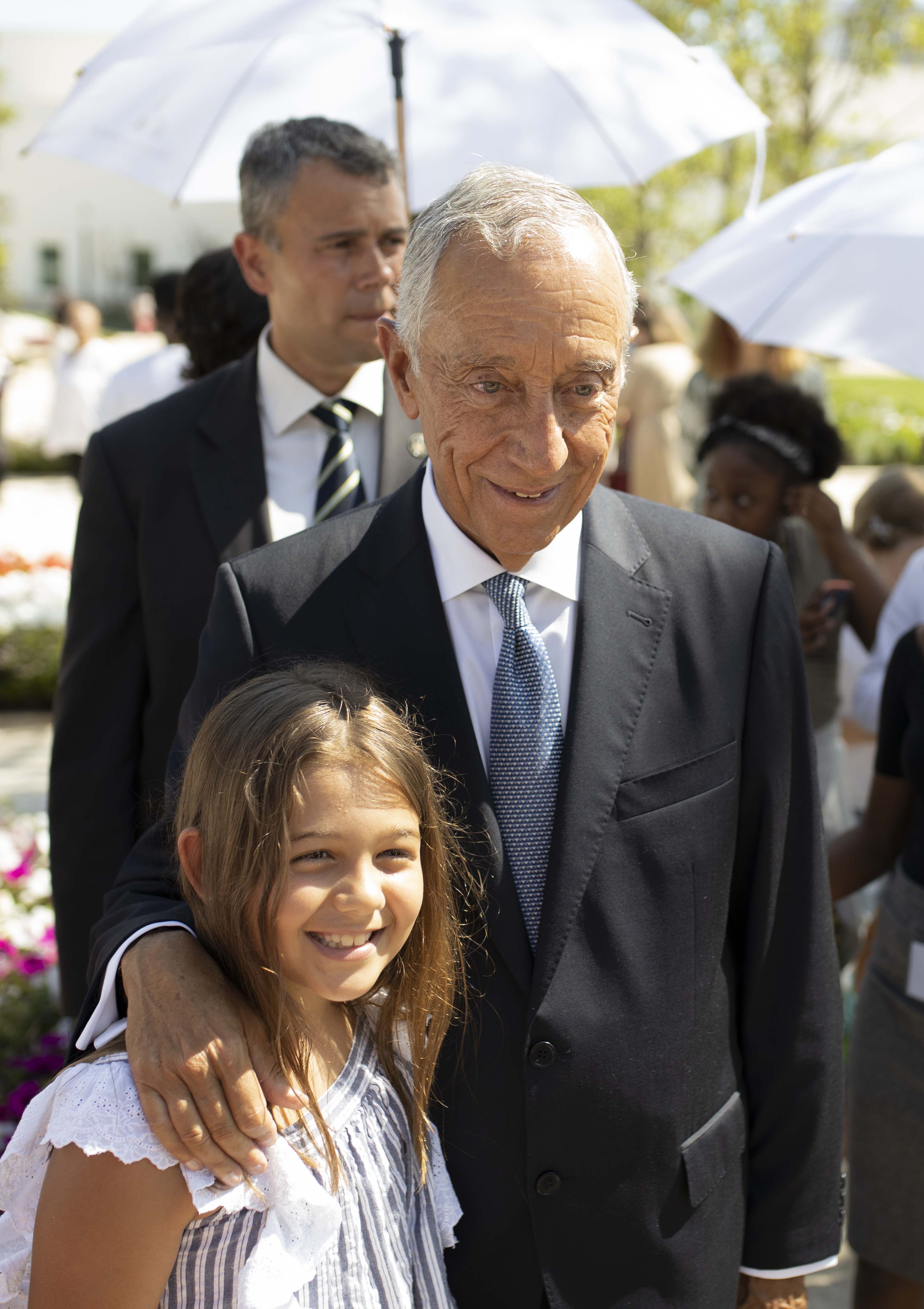 The president of Portugal, Marcelo Rebelo de Sousa takes a picture with a child on the Lisbon Portugal Temple grounds on Aug. 29, 2019.