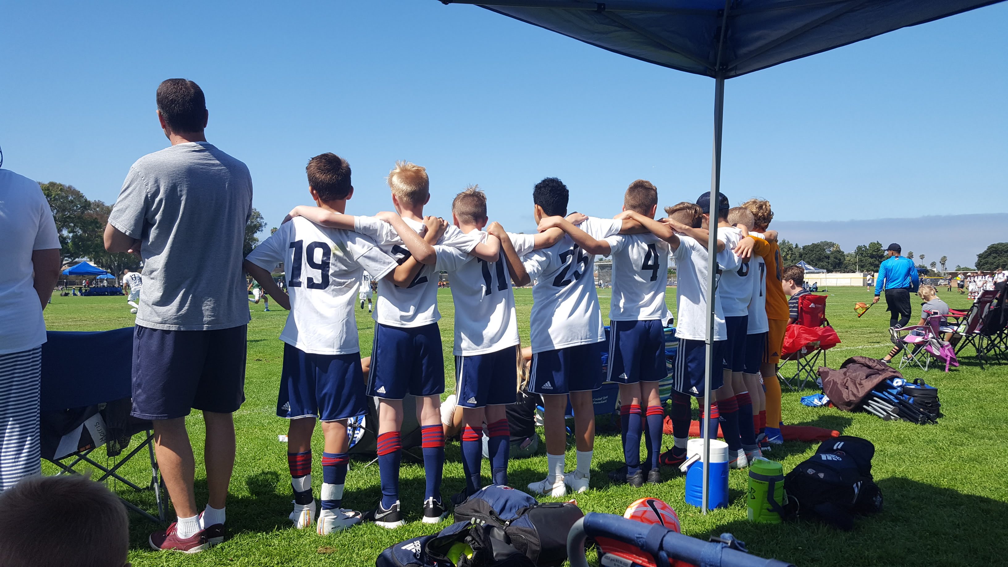 The 2007 Boys Blue soccer team stands with their arms around each other during a tournament in La Jolla in San Diego, California in September 2019.
