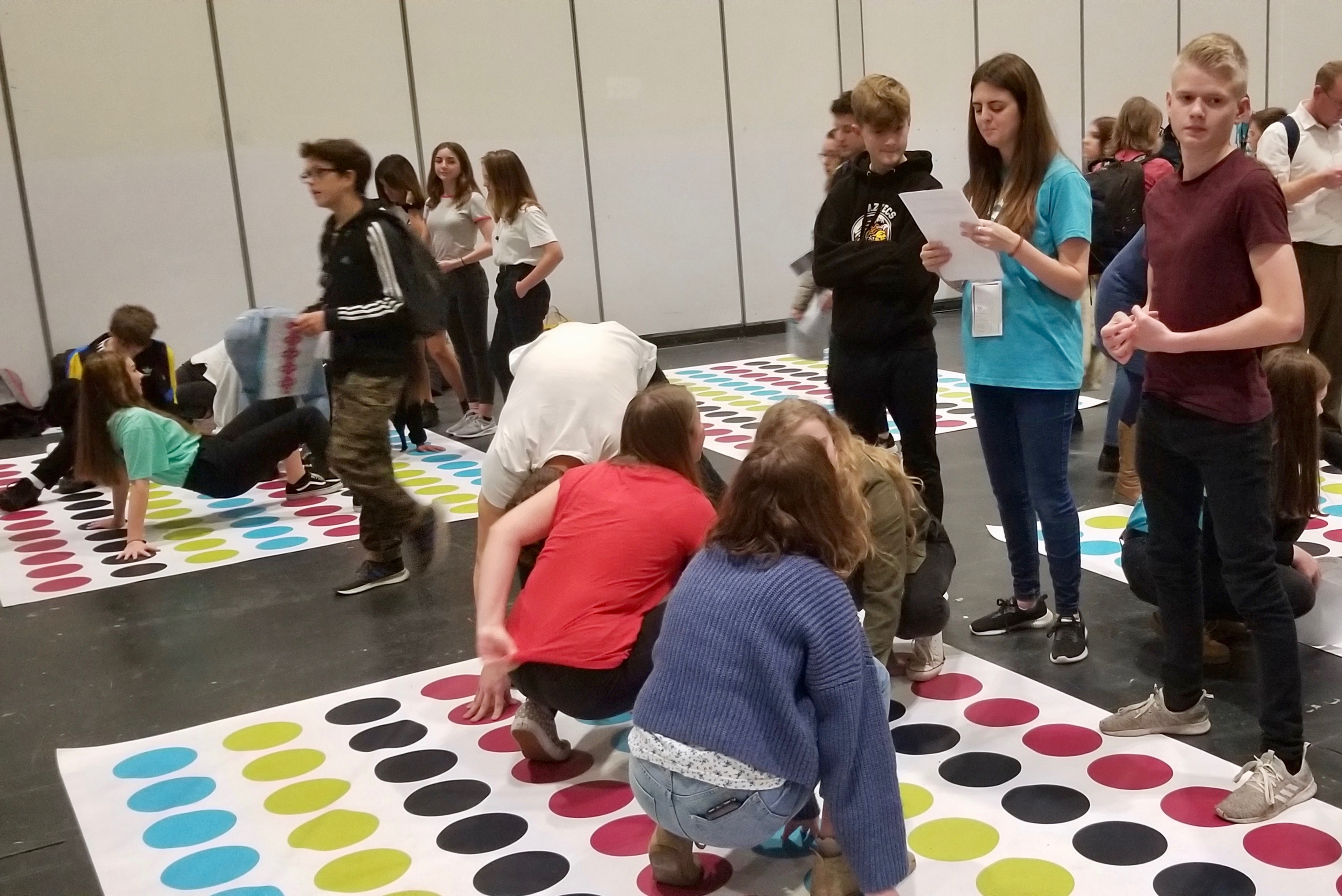 Youth play in a family history-themed version of Twister in a RootsTech London discovery activity on Oct. 26, 2019.