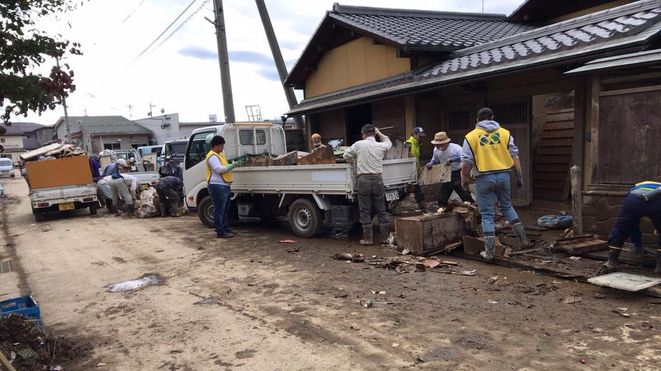 Volunteers carry out household goods from damaged houses following flooding from Typhoon Hagibis and its aftermath in October 2019.