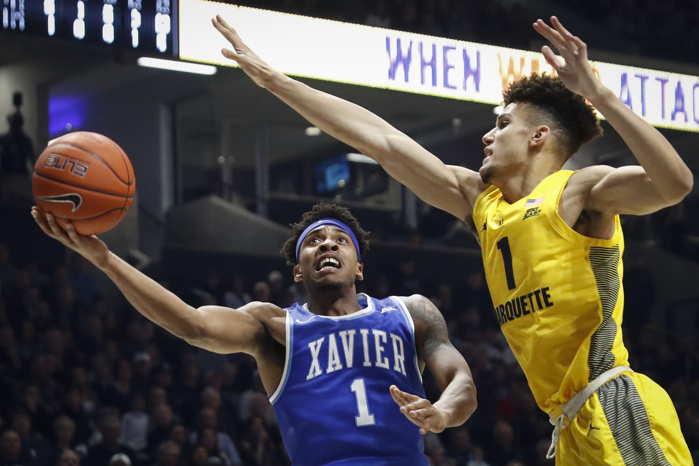 Xavier guard Paul Scruggs, left, shoots against Marquette forward Brendan Bailey in a game in the 2018-2019 season in Cincinnati.