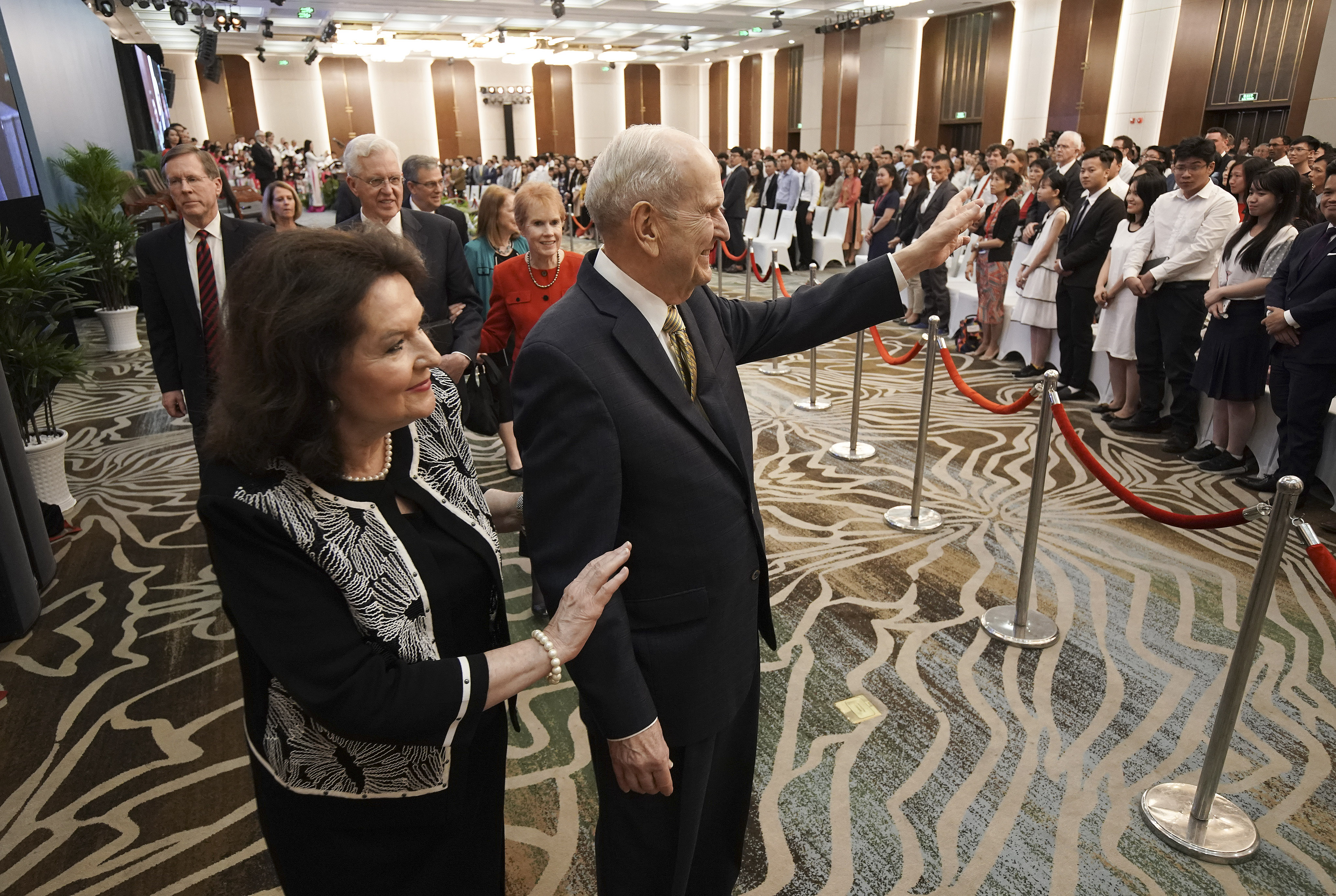 President Russell M. Nelson of The Church of Jesus Christ of Latter-day Saints and his wife, Sister Wendy Nelson, wave after a devotional in Ho Chi Minh City, Vietnam, on Nov. 18, 2019.