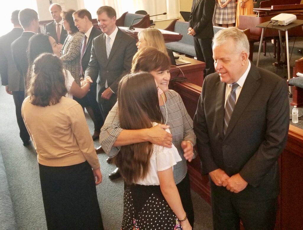 Elder Brent H. Nielson and Sister Marcia Nielson greet a sister missionary, as Sister Mary Rasband, Elder James R. Rasband, President Rhys A. Weaver and Sister Pamela Weaver welcome others at the start of a Tennessee Nashville Mission tour conference session on Sept. 19, 2019, in Brentwood, Tennessee.