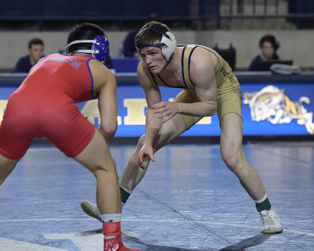 Navy wrestler Casey Cobb, right, a returned missionary from Kuna, Idaho, sizes up his opponent from American University.