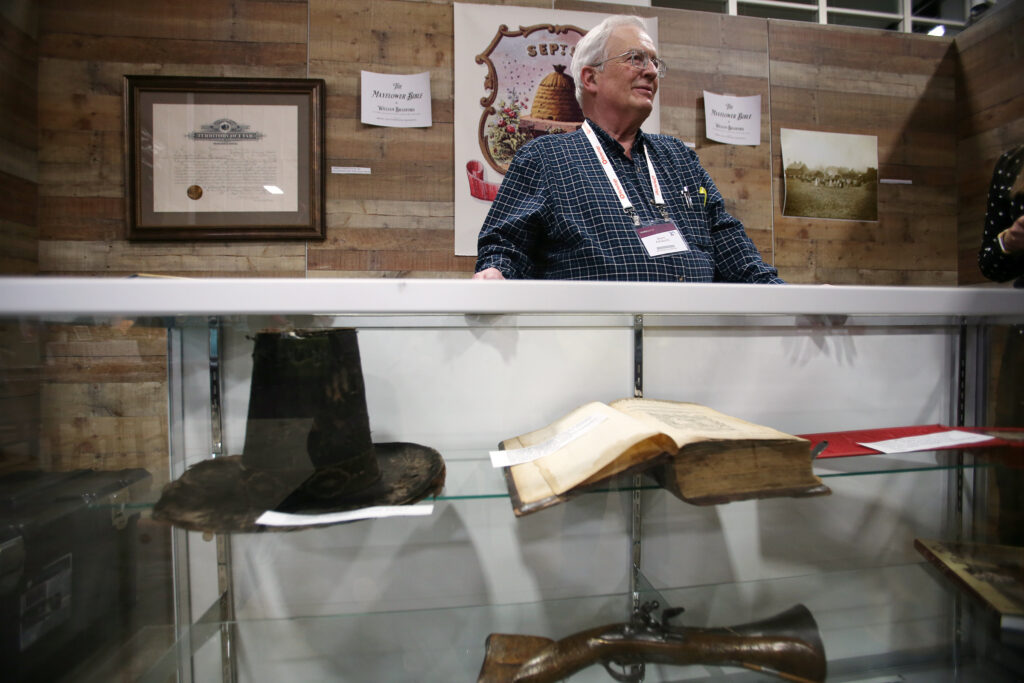 Collector Brent Ashworth talks with visitors about the John Calvin New Testament Bible in Old Dutch that sailed on the Mayflower and is on display during RootsTech at the Salt Palace Convention Center in Salt Lake City on Friday, Feb. 28, 2020.