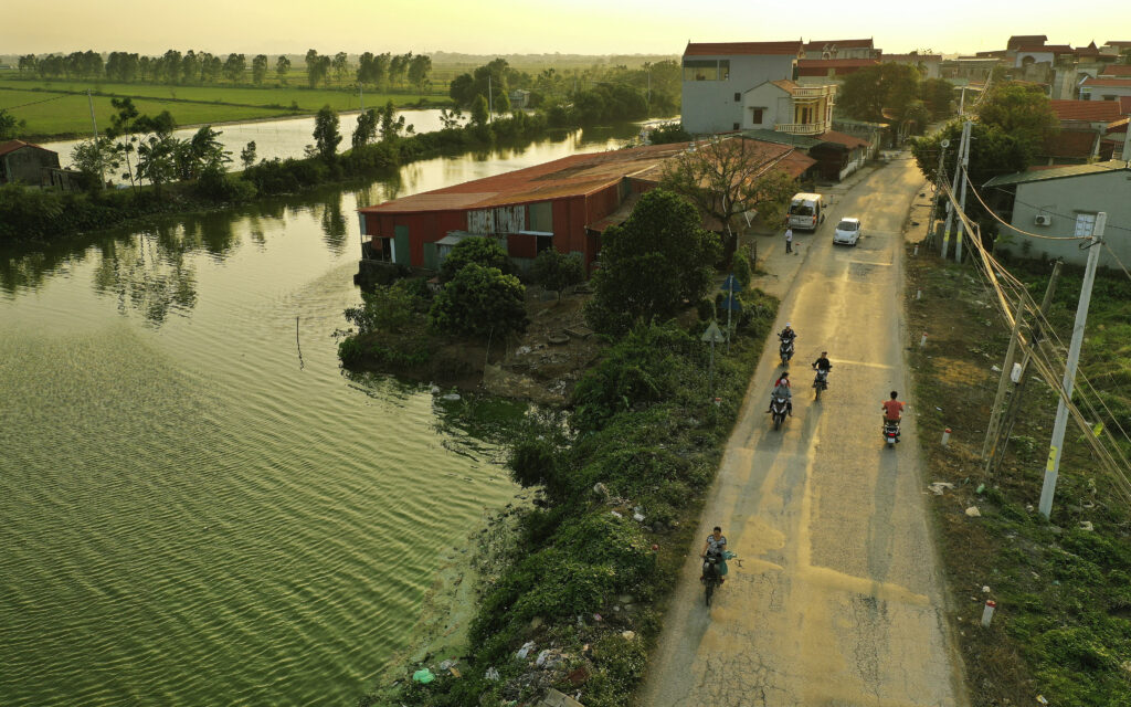 Motoristas viajan cerca del agua en Hanói, Vietnam, el sábado 16 de noviembre de 2019.